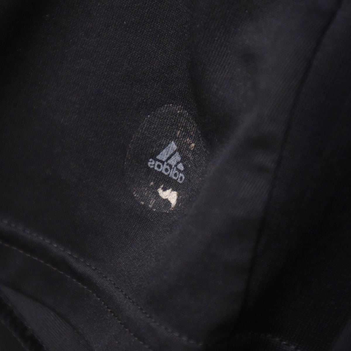 Close-up of the faded inner size label reading adidas and M on the Germany away shirt