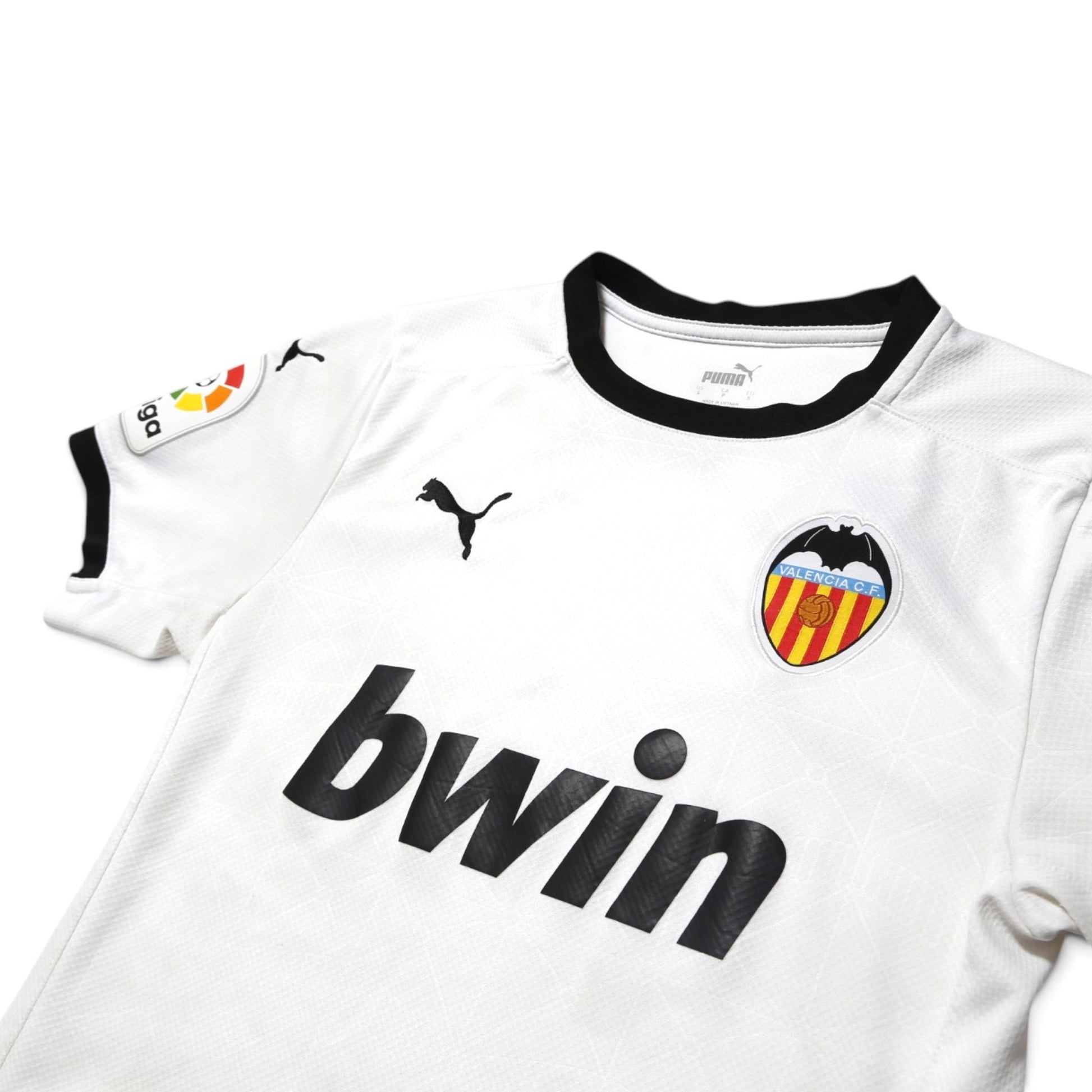 Close-up of Valencia CF home shirt collar, Puma logo and crest