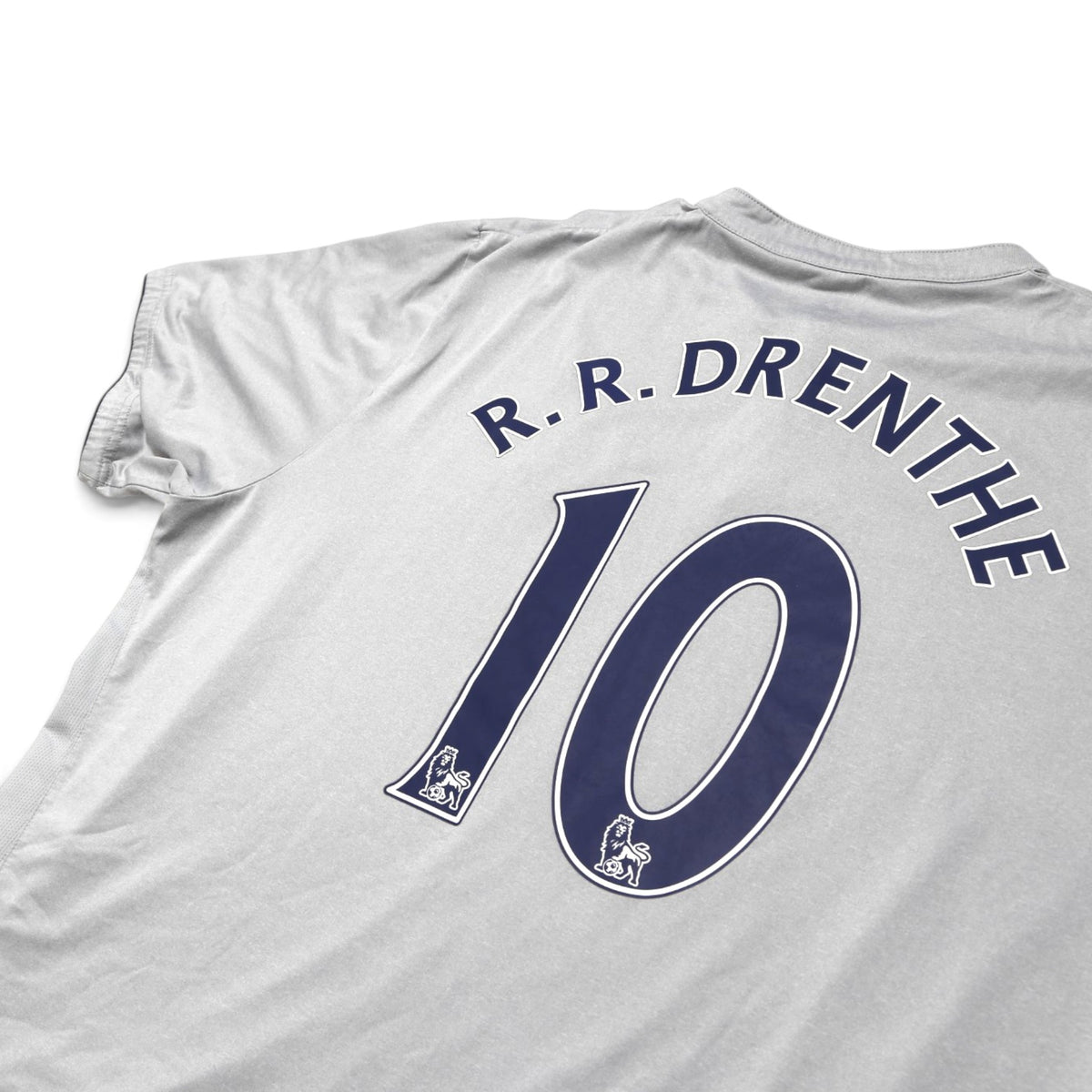 Close-up of Everton shirt collar and shoulder showing Drenthe #10 print and fabric texture
