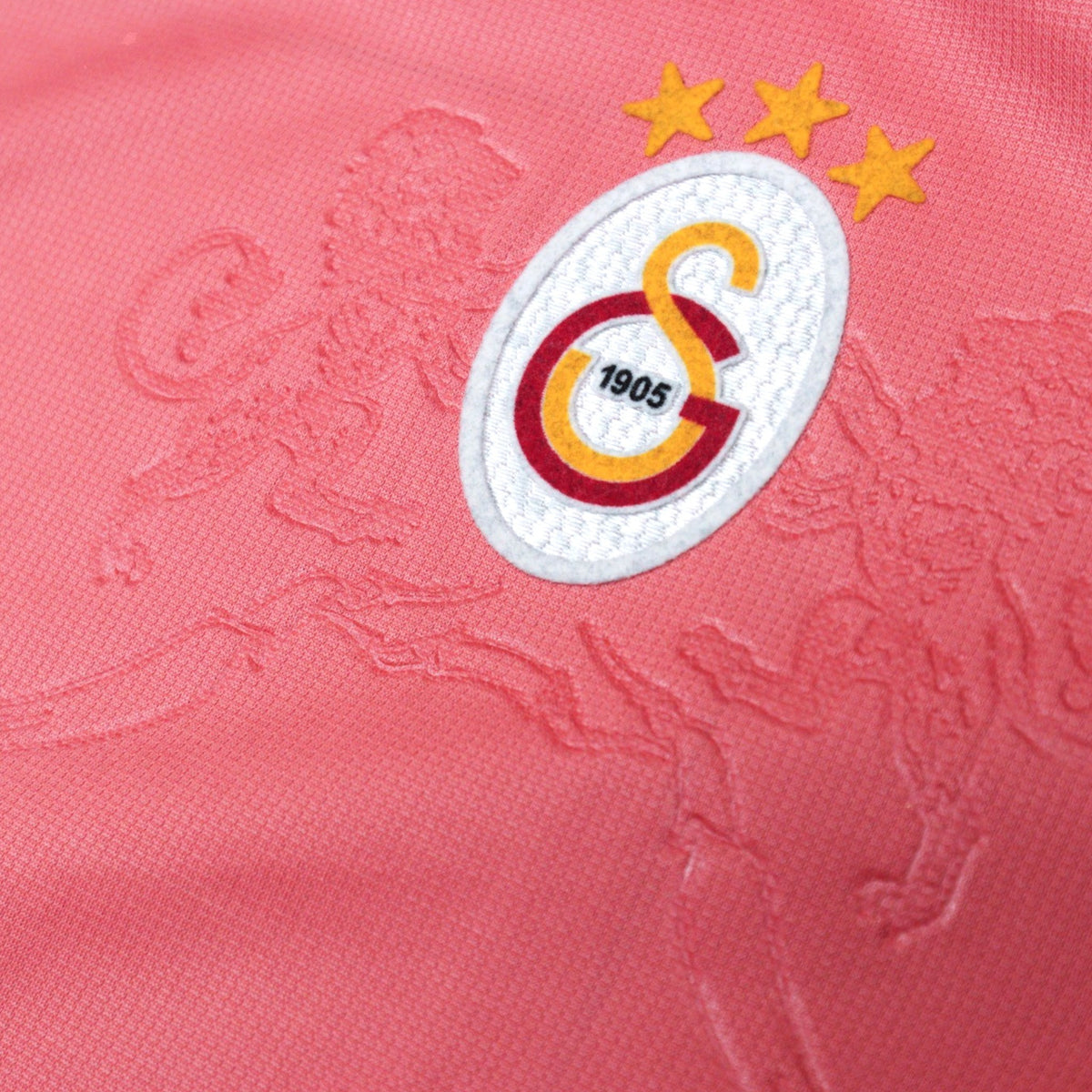 Close-up of the Galatasaray crest with three stars above it