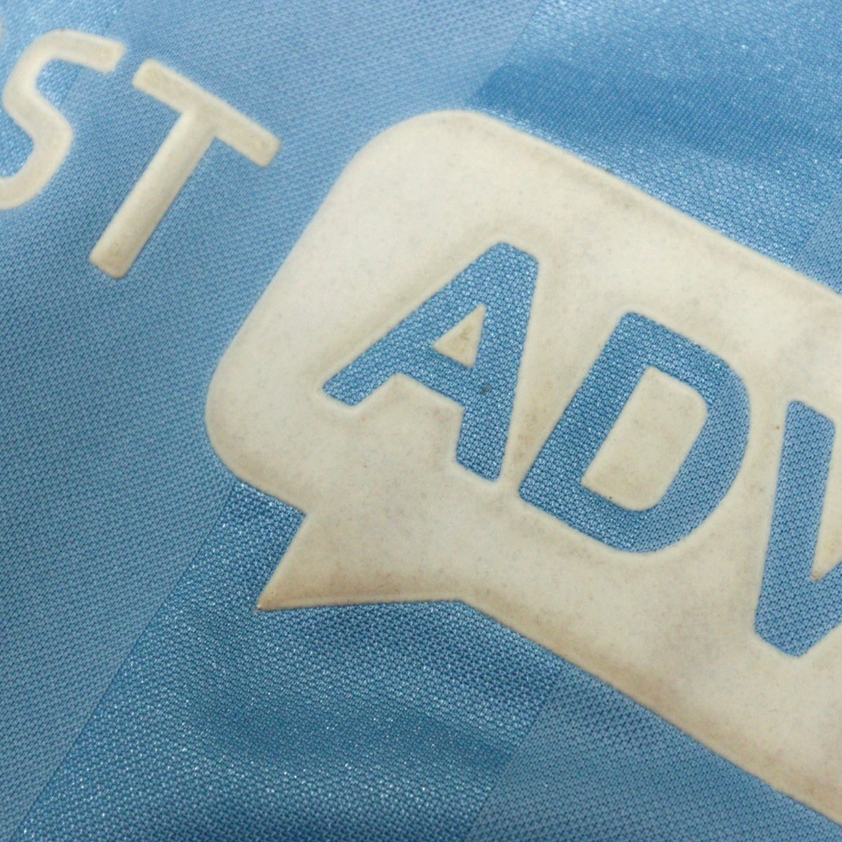 Close-up of the First Advice sponsor print showing light yellowing