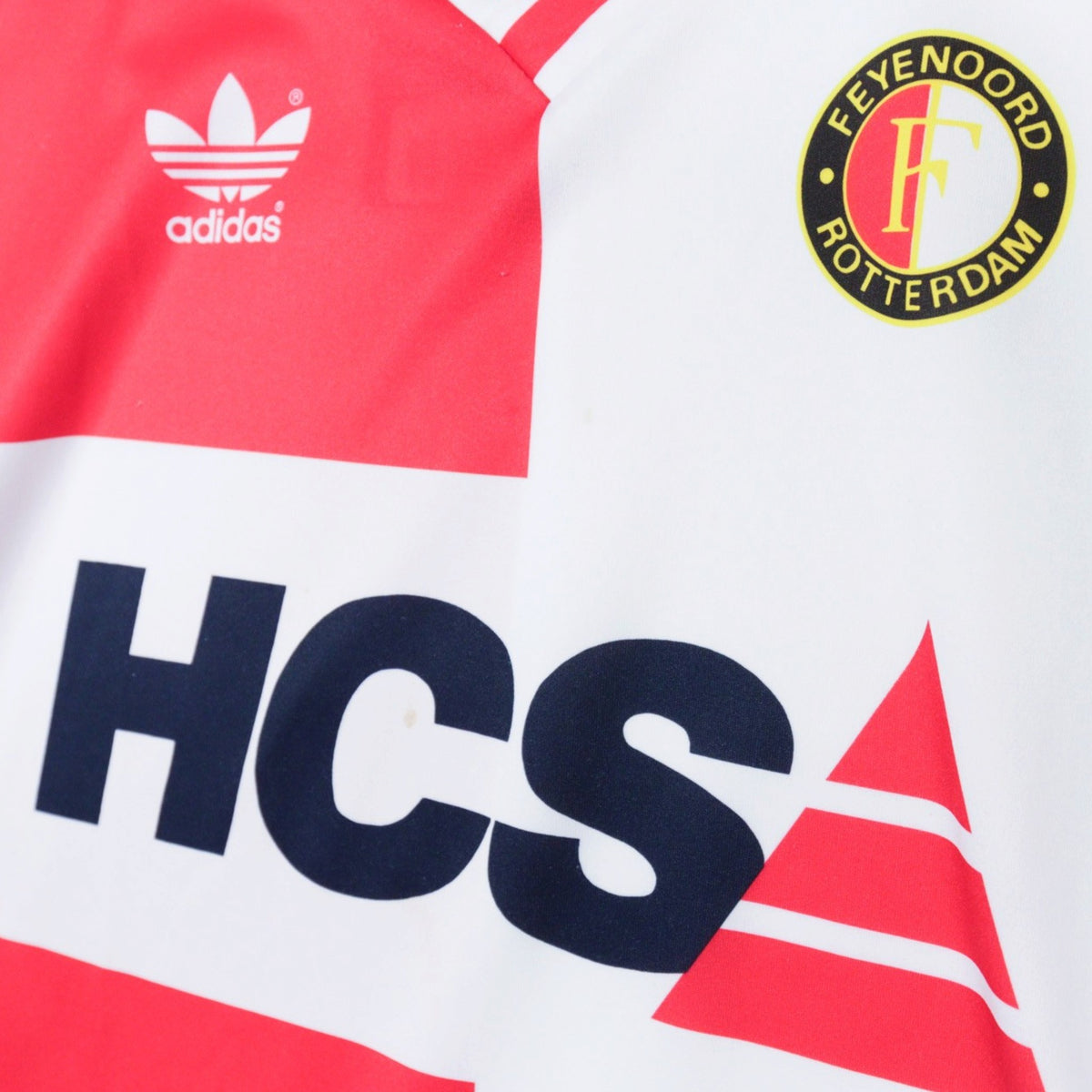 Close-up of adidas trefoil logo, Feyenoord crest and HCS sponsor on the chest