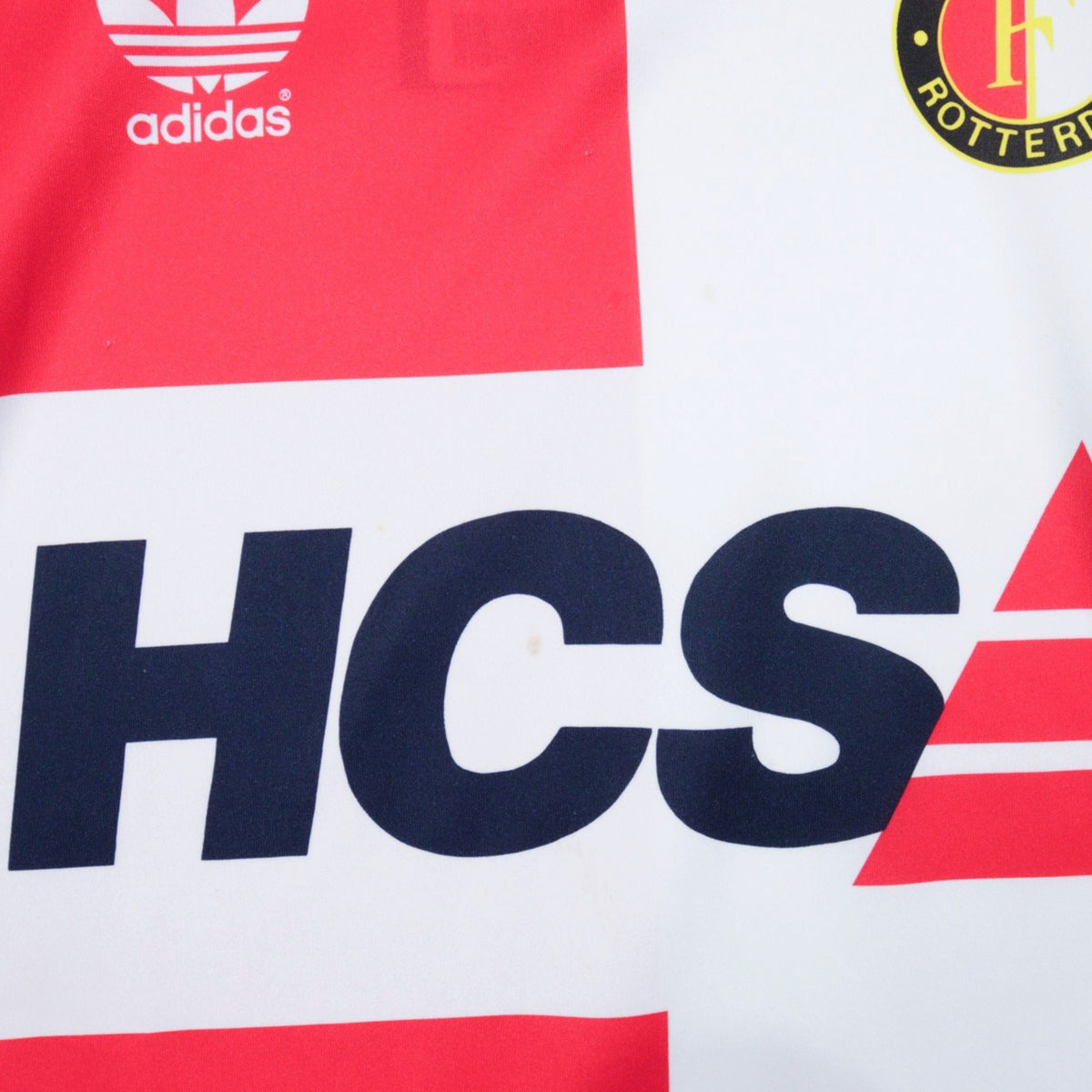 Close-up detail of the HCS sponsor print and adidas logo on the chest