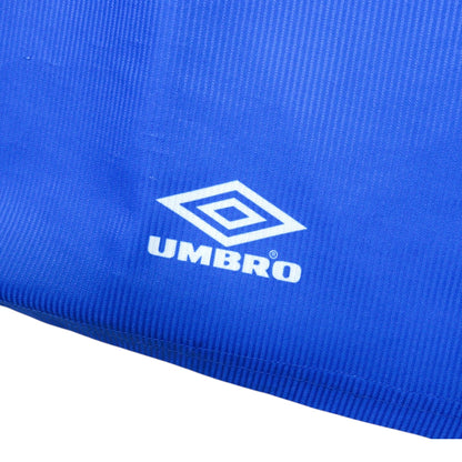Close-up of the Umbro logo printed on the hem of the shirt