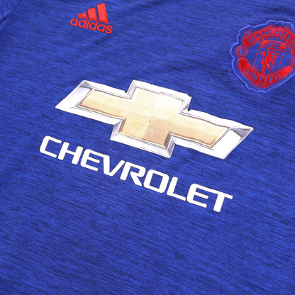 Close-up of adidas logo, Manchester United crest and Chevrolet sponsor on chest