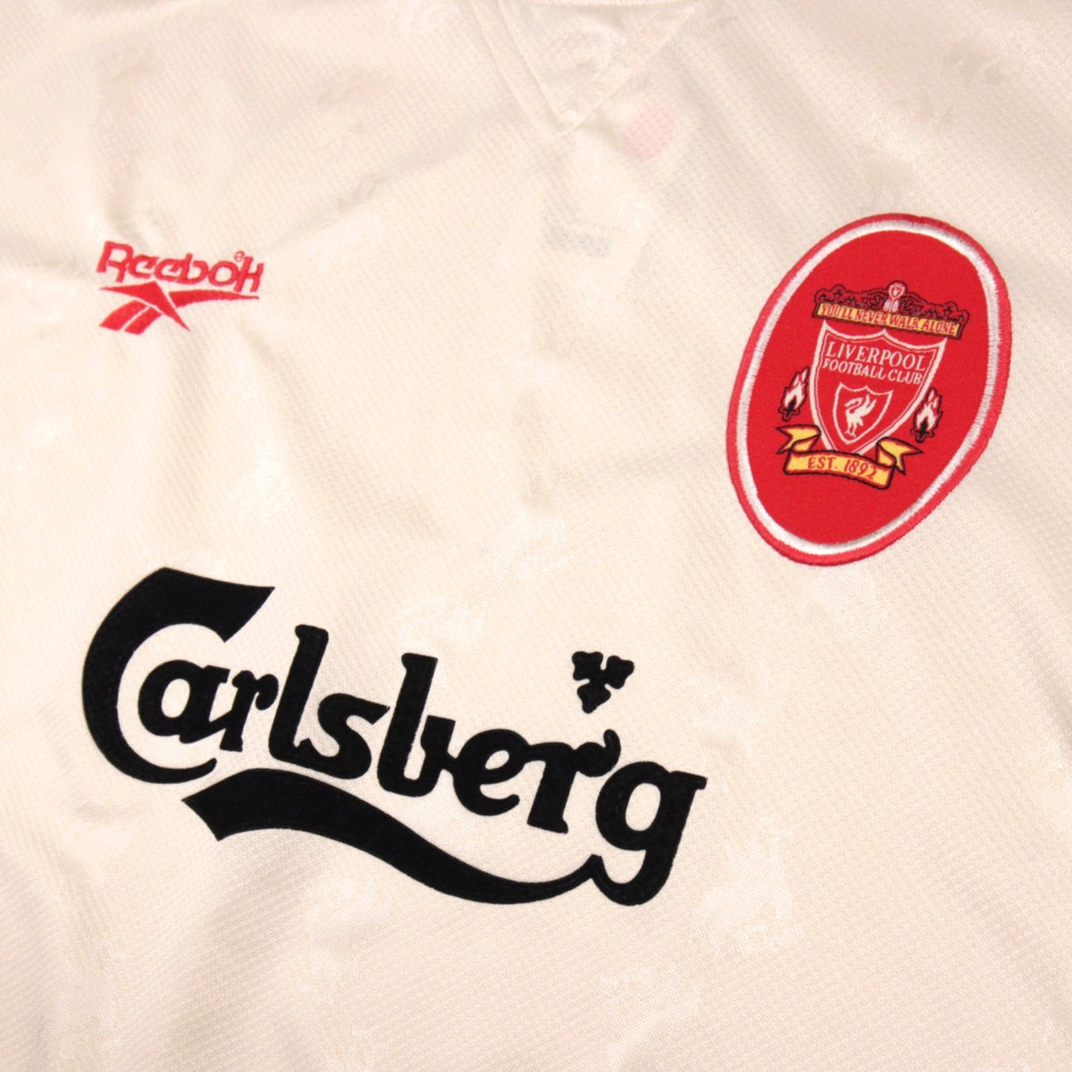 Close-up of Liverpool crest, Reebok logo and Carlsberg sponsor on the 1996/97 away shirt