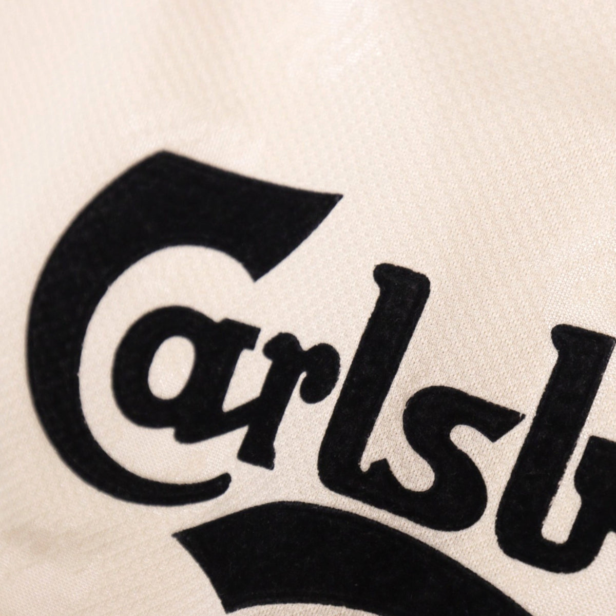 Close-up of the Carlsberg sponsor print on the shirt