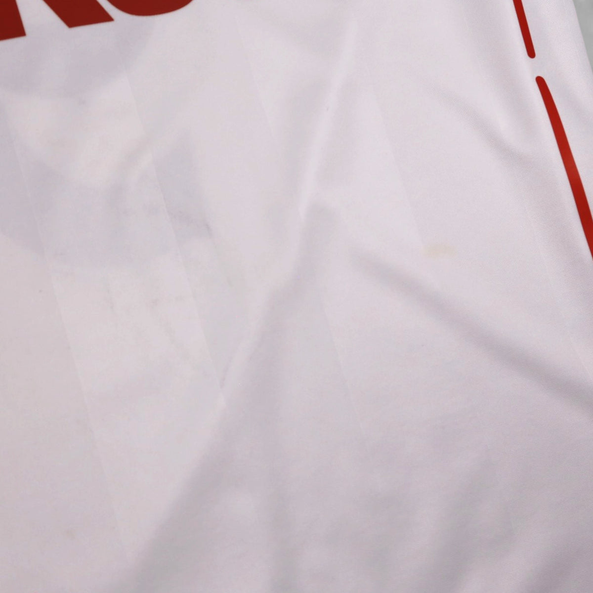 Close-up of fabric showing a small faint mark near the front pinstripe