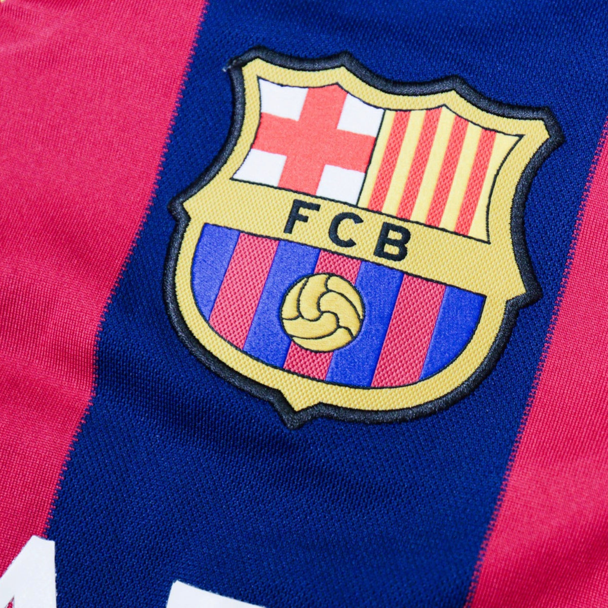 Close-up of the embroidered FCB crest on the chest