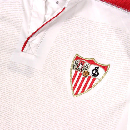 Close-up of the collar, placket and Sevilla crest with size label visible