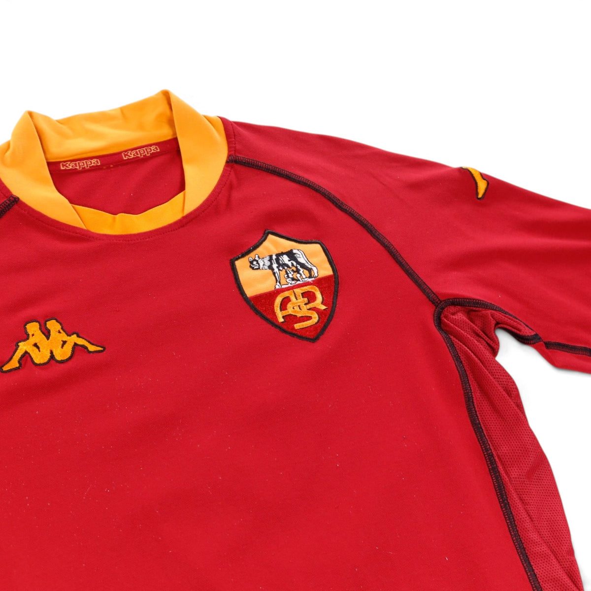Close-up of the Roma crest, collar and Kappa logo on the shirt
