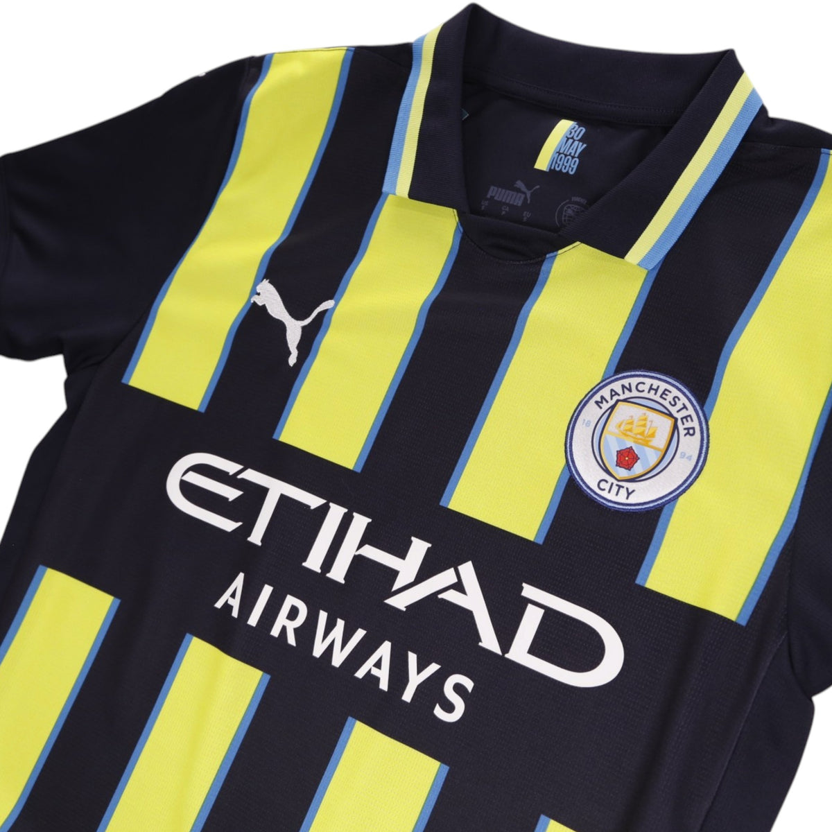 Close-up of collar, crest and sponsor on the chest of the shirt