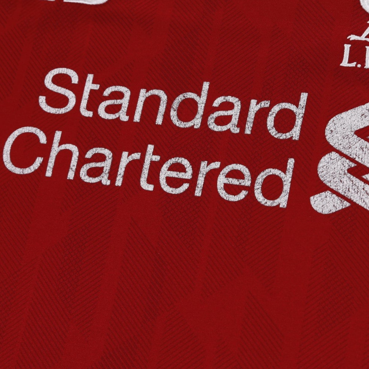 Close-up of Standard Chartered sponsor print on chest