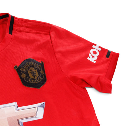 Close-up of Manchester United crest and adidas logo on the chest