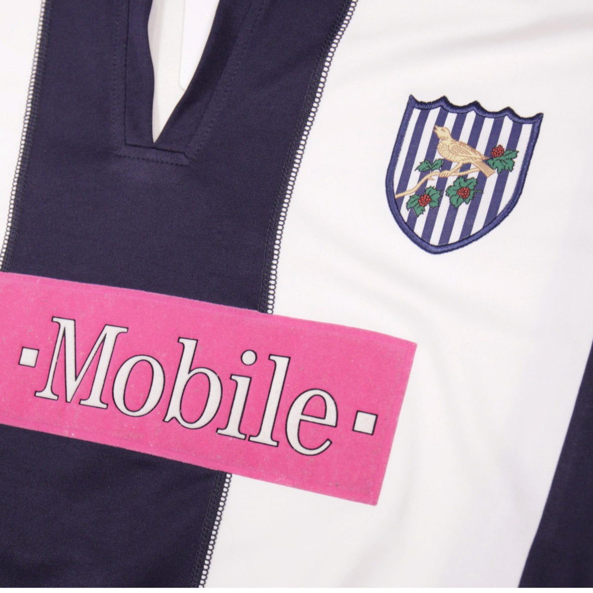 Close-up of West Bromwich Albion crest and T-Mobile sponsor print on the shirt