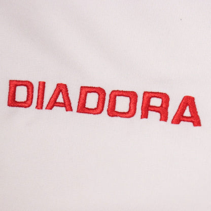 Close-up of the embroidered Diadora logo on the shirt front
