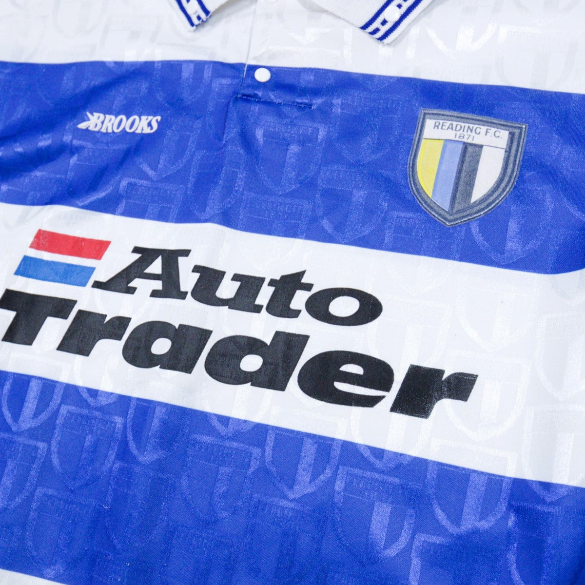 Close-up of Reading F.C. crest and Auto Trader sponsor on the shirt