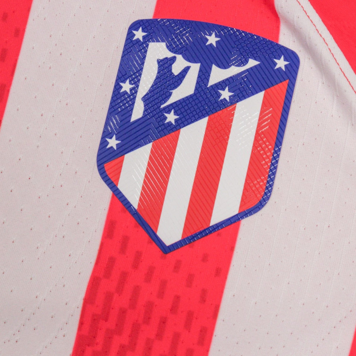 Close-up of the Atletico Madrid crest with blue shield and white stars