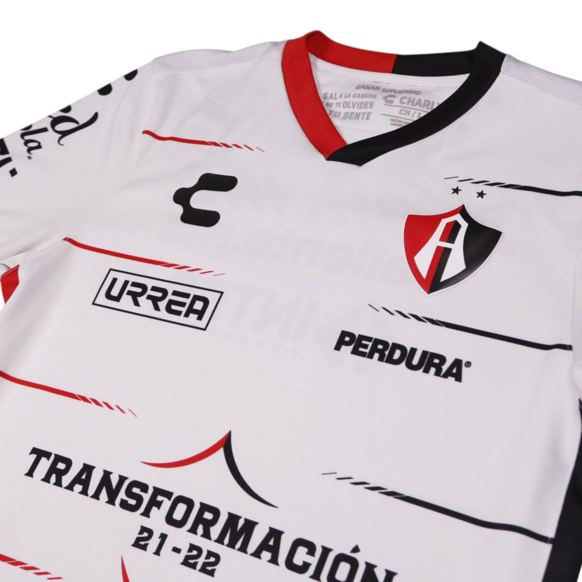 Close-up of Atlas crest, Charly logo and collar trim on the away shirt