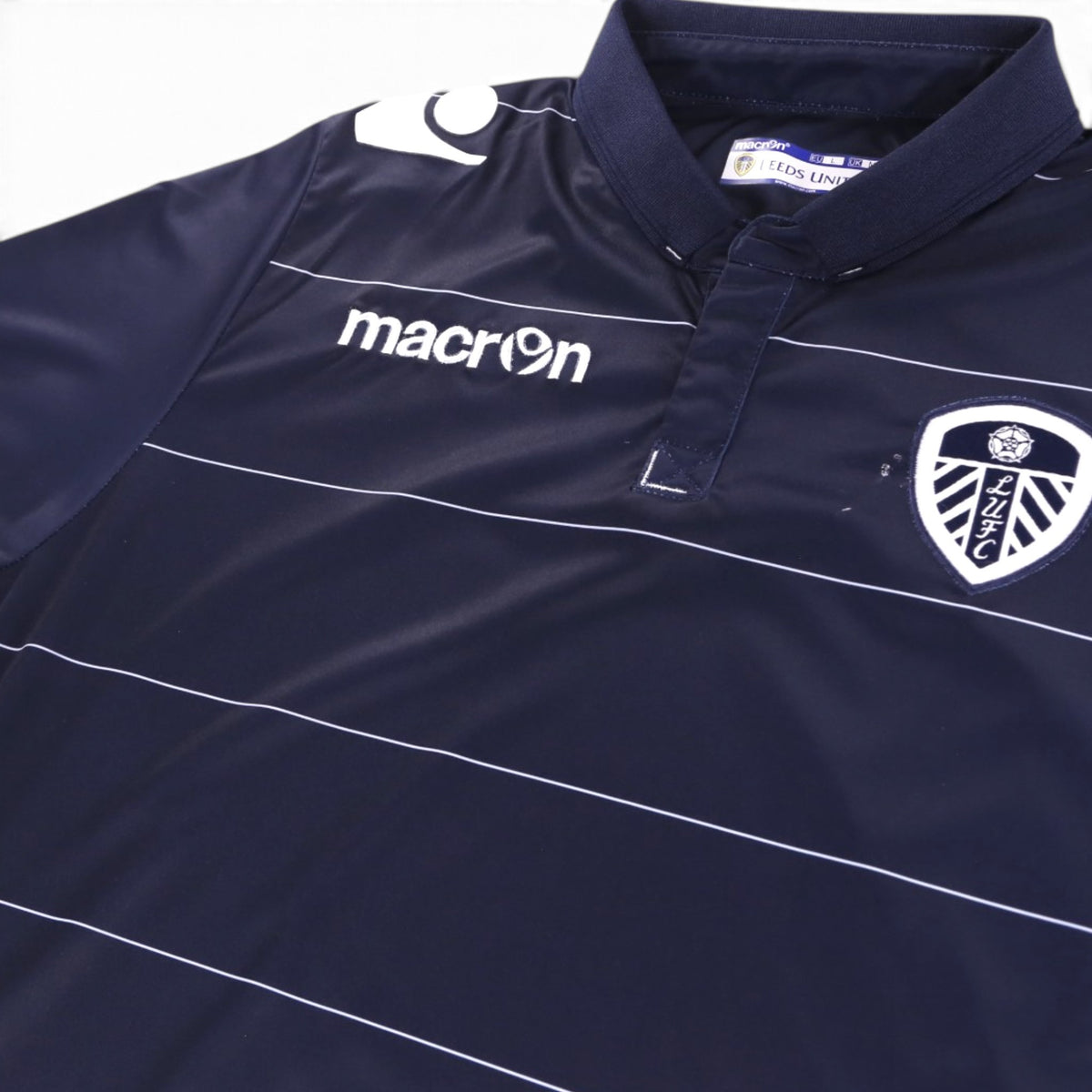 Close-up of the collar, placket and neck label of the Leeds United shirt