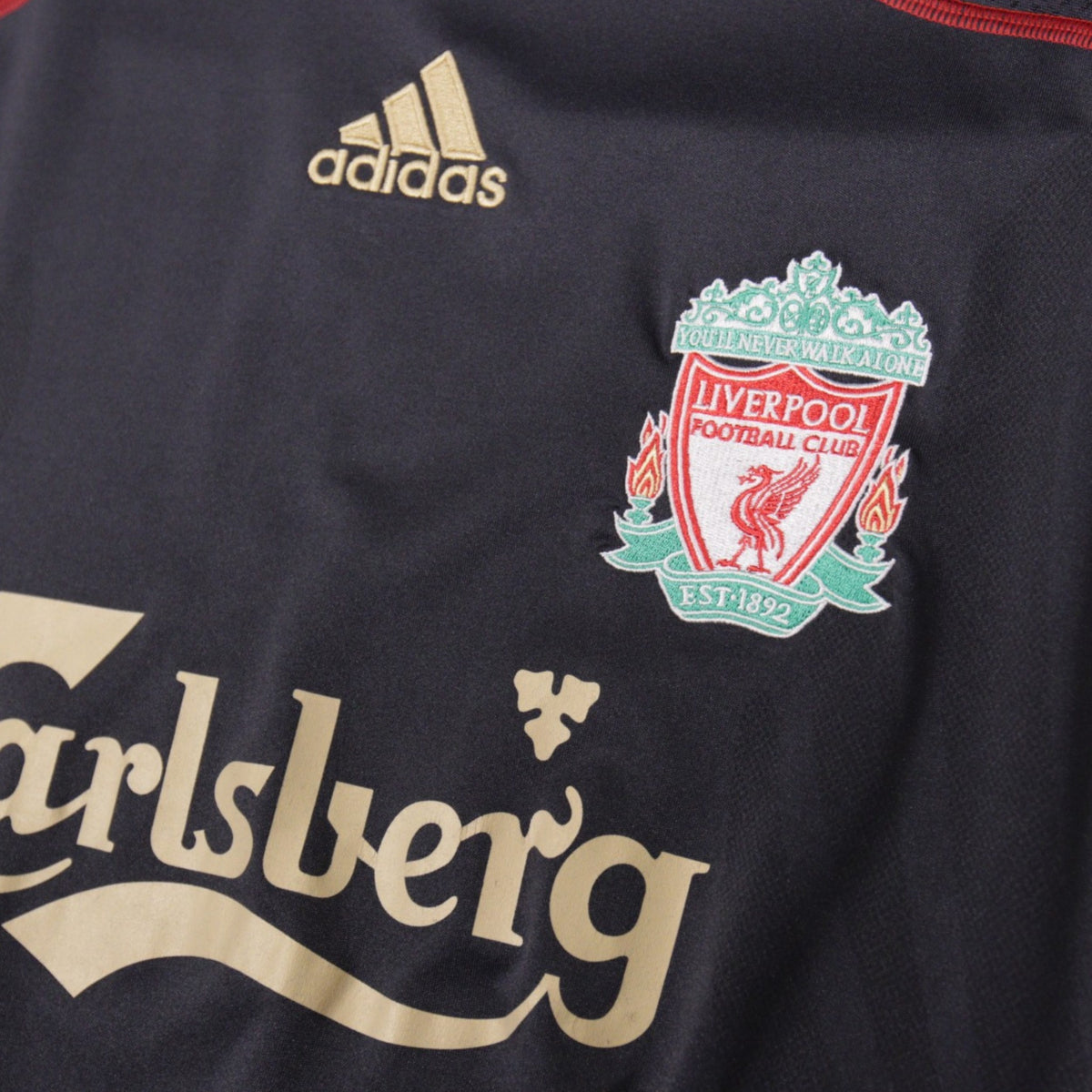 Close-up of Liverpool crest and adidas logo on 2009/10 away shirt