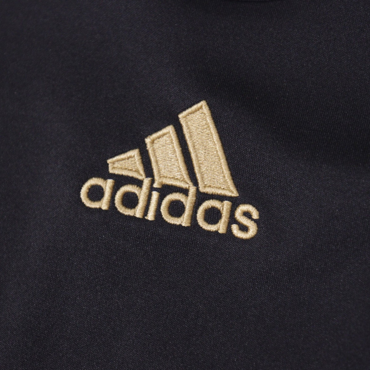 Close-up of adidas logo embroidered on shirt sleeve