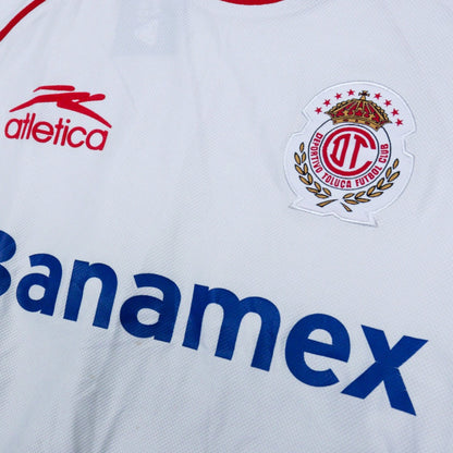 Close-up of the Atletica logo and Deportivo Toluca crest on the chest