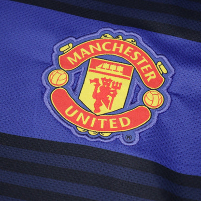 Close-up of Manchester United embroidered crest on blue fabric
