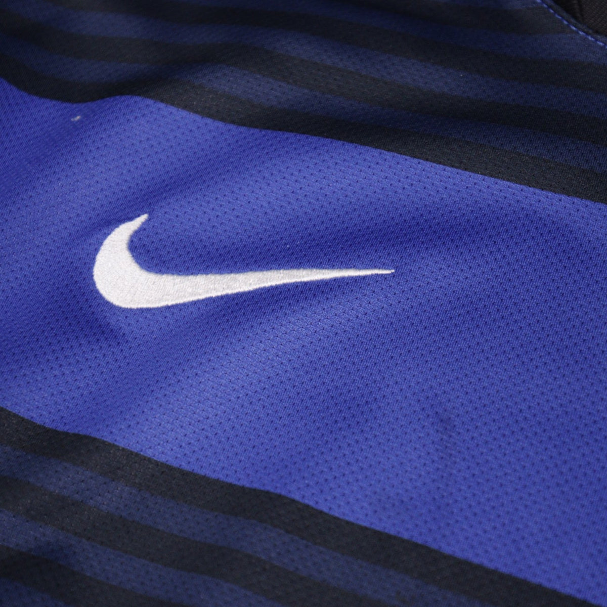 Close-up of Nike swoosh logo on sleeve fabric