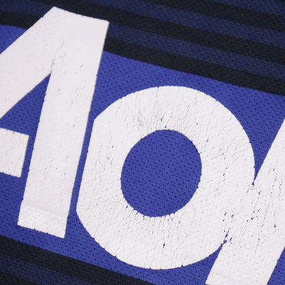 Close-up of cracked Aon sponsor print lettering