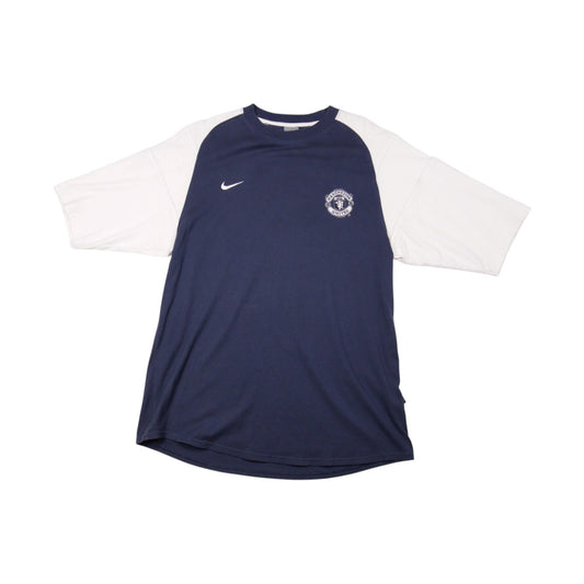 Front view of navy Manchester United Nike training shirt with white raglan sleeves