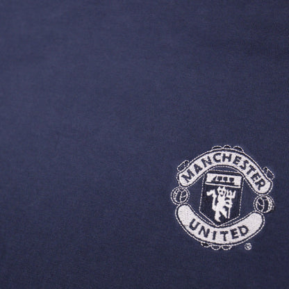 Close-up of the embroidered Manchester United crest on the chest