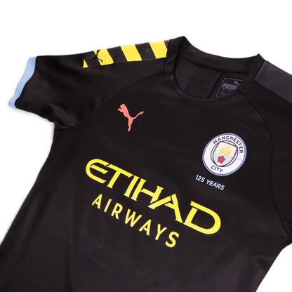Close-up of the chest showing the Manchester City crest, Puma logo and neck label