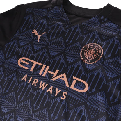 Close-up of Manchester City crest, Puma logo and Etihad Airways sponsor on chest