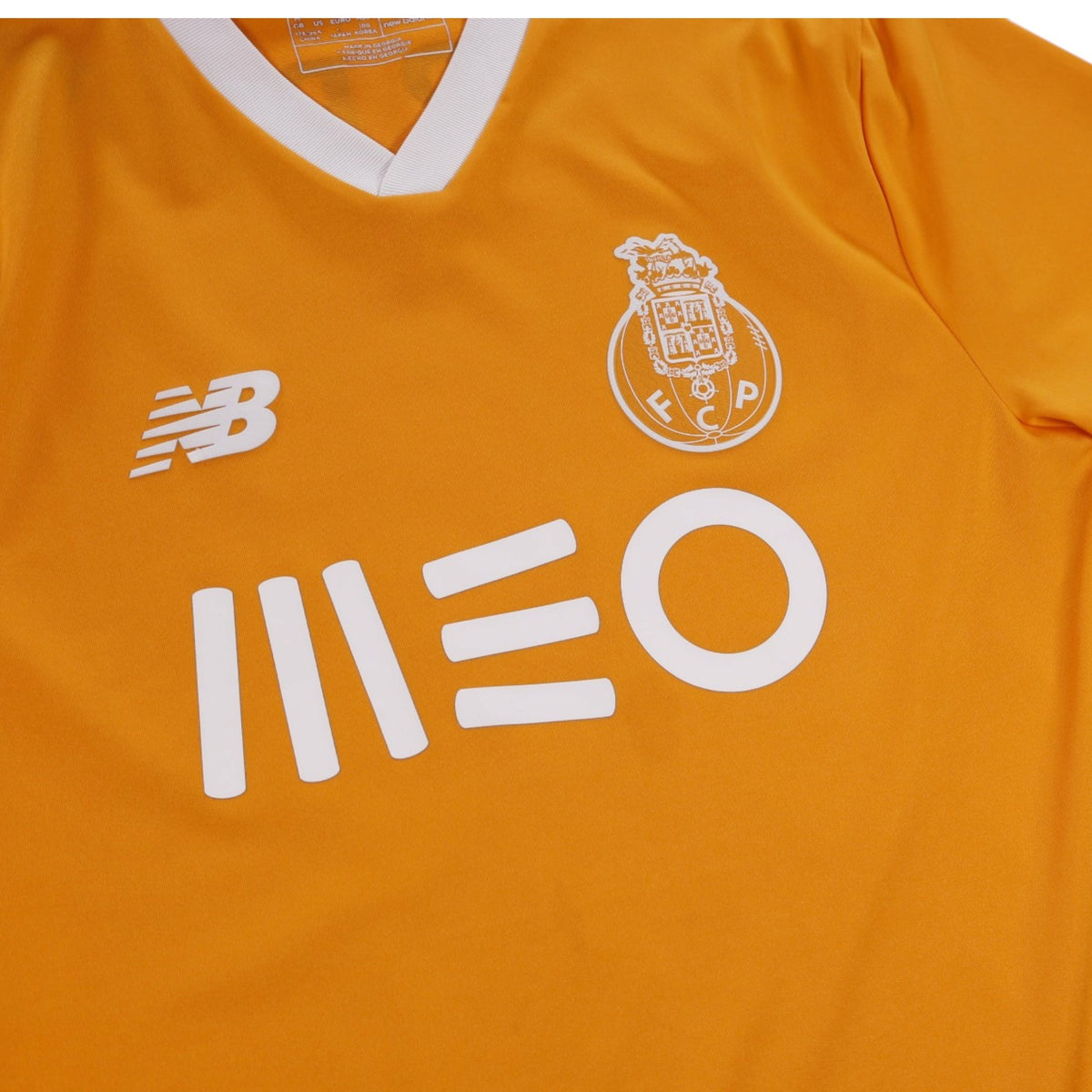 Close-up of FC Porto away shirt showing New Balance logo, crest and MEO sponsor
