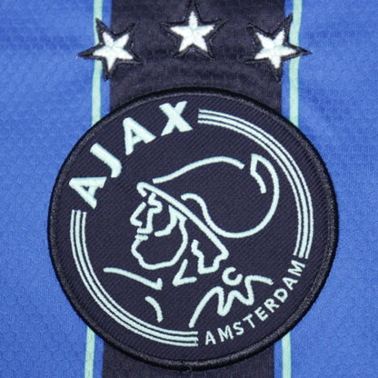 Close-up of Ajax crest with three stars above on away shirt
