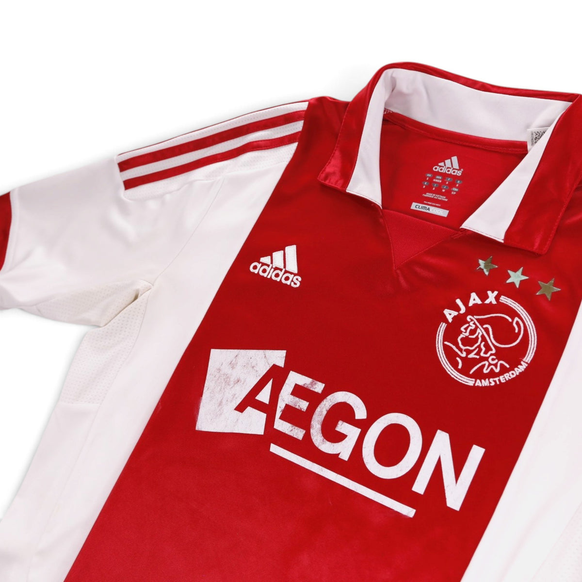 Close-up of the adidas logo, Ajax crest and collar on the home shirt