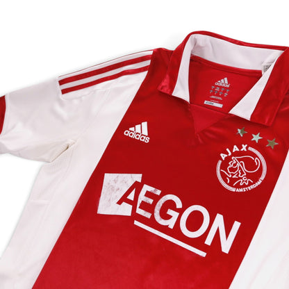Close-up of the adidas logo, Ajax crest and collar on the home shirt