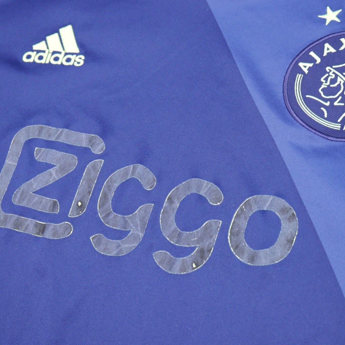 Close-up of Ajax crest, adidas logo and Ziggo sponsor print on the away shirt
