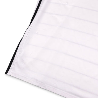 Close-up of the shirt hem and side seam showing small fabric pulls
