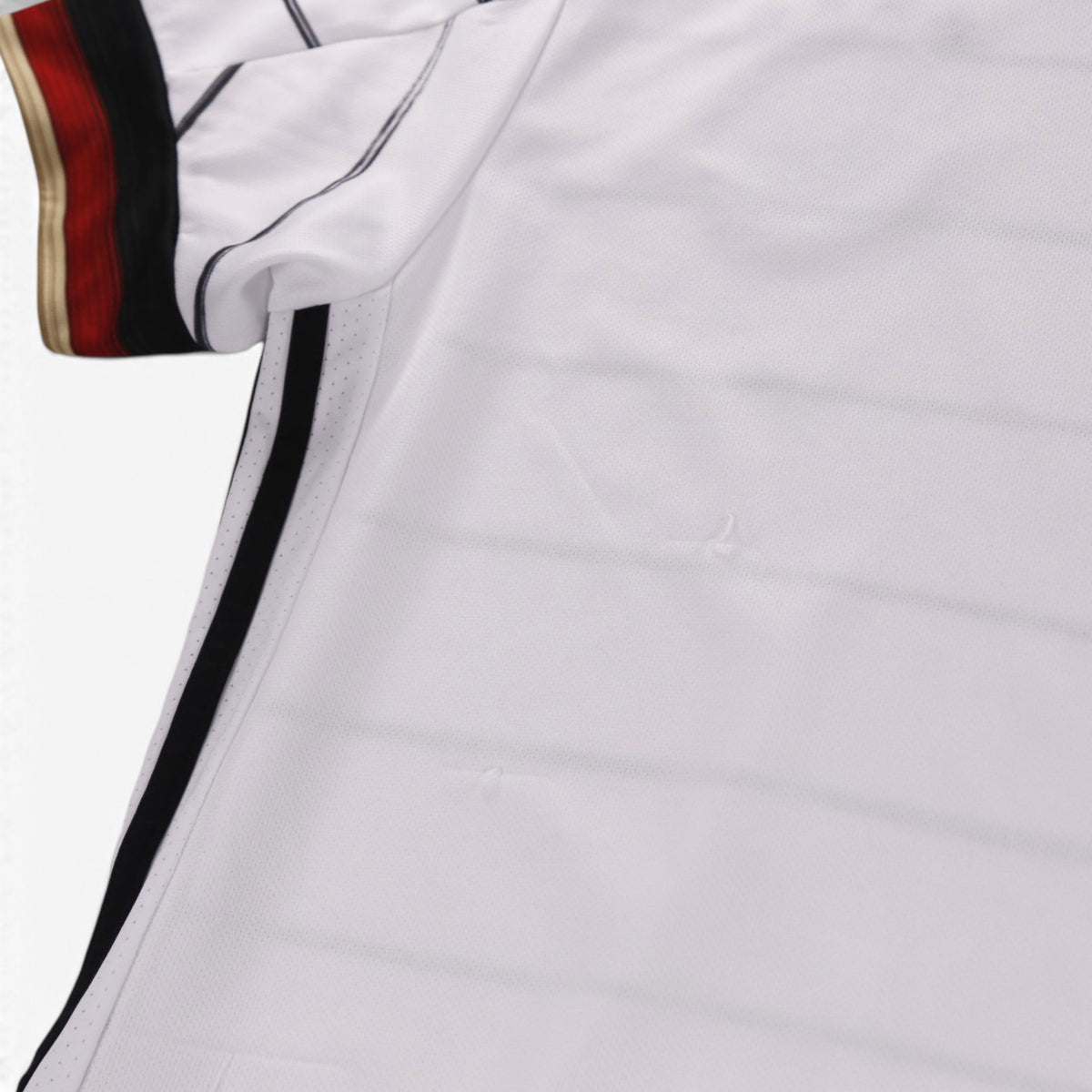 Close-up of the sleeve cuff and fabric showing small pulls in the material