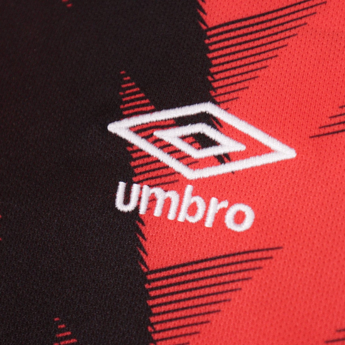 Close-up of Umbro logo on shirt fabric