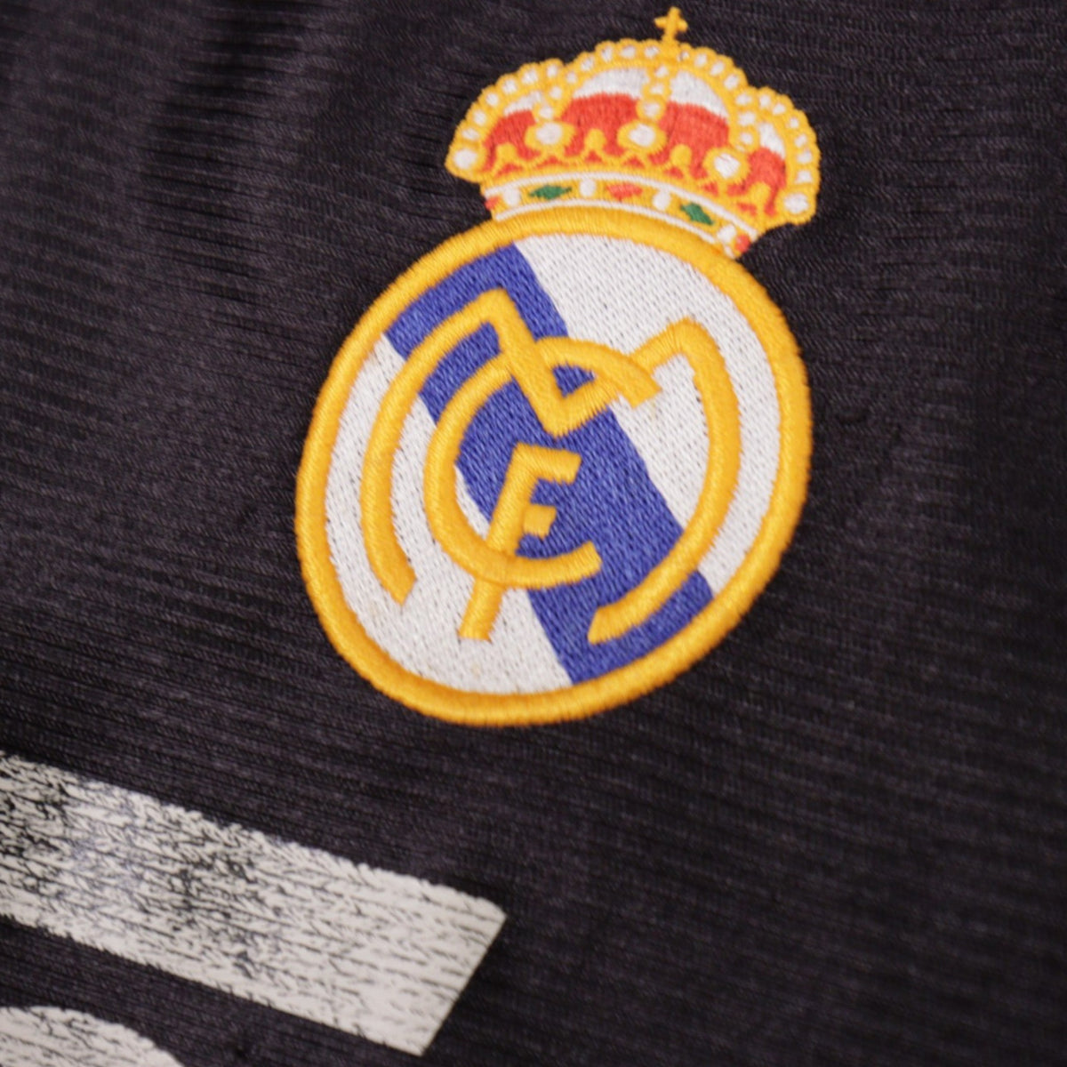 Close-up of embroidered Real Madrid crest on 1999/00 away shirt