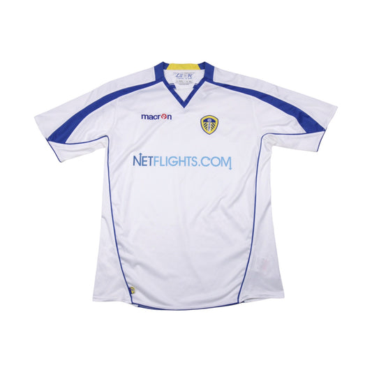 Front view of Leeds United white home shirt with Netflights.com sponsor and Macron logo