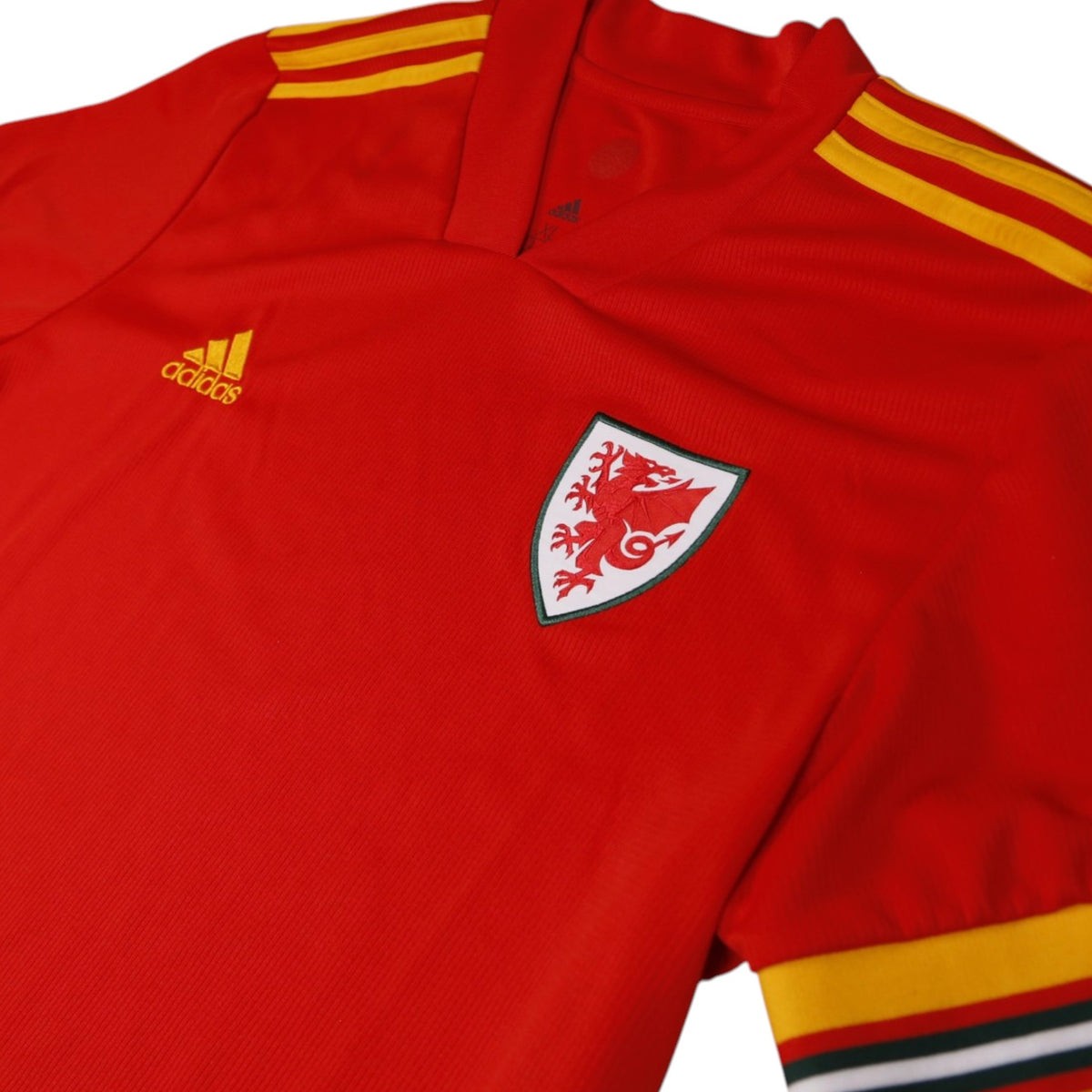 Close-up of Wales crest and adidas logo on the shirt