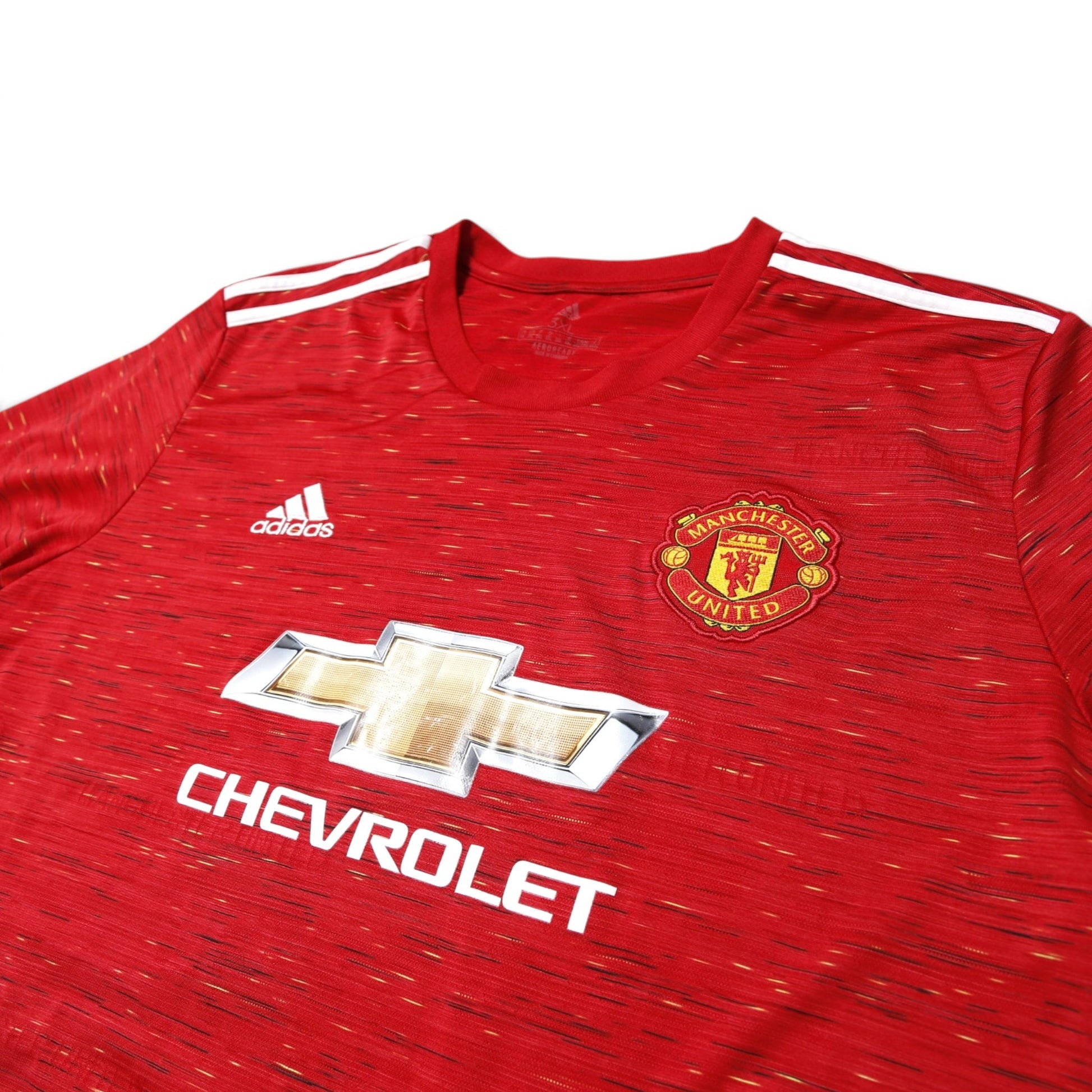 Manchester United 2020/21 home shirt front detail showing crest, adidas logo, and Chevrolet branding