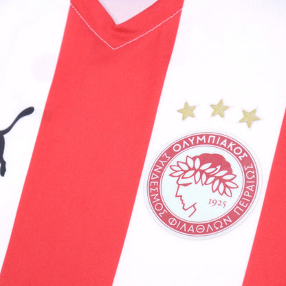 Close-up of Olympiacos crest and three stars on chest