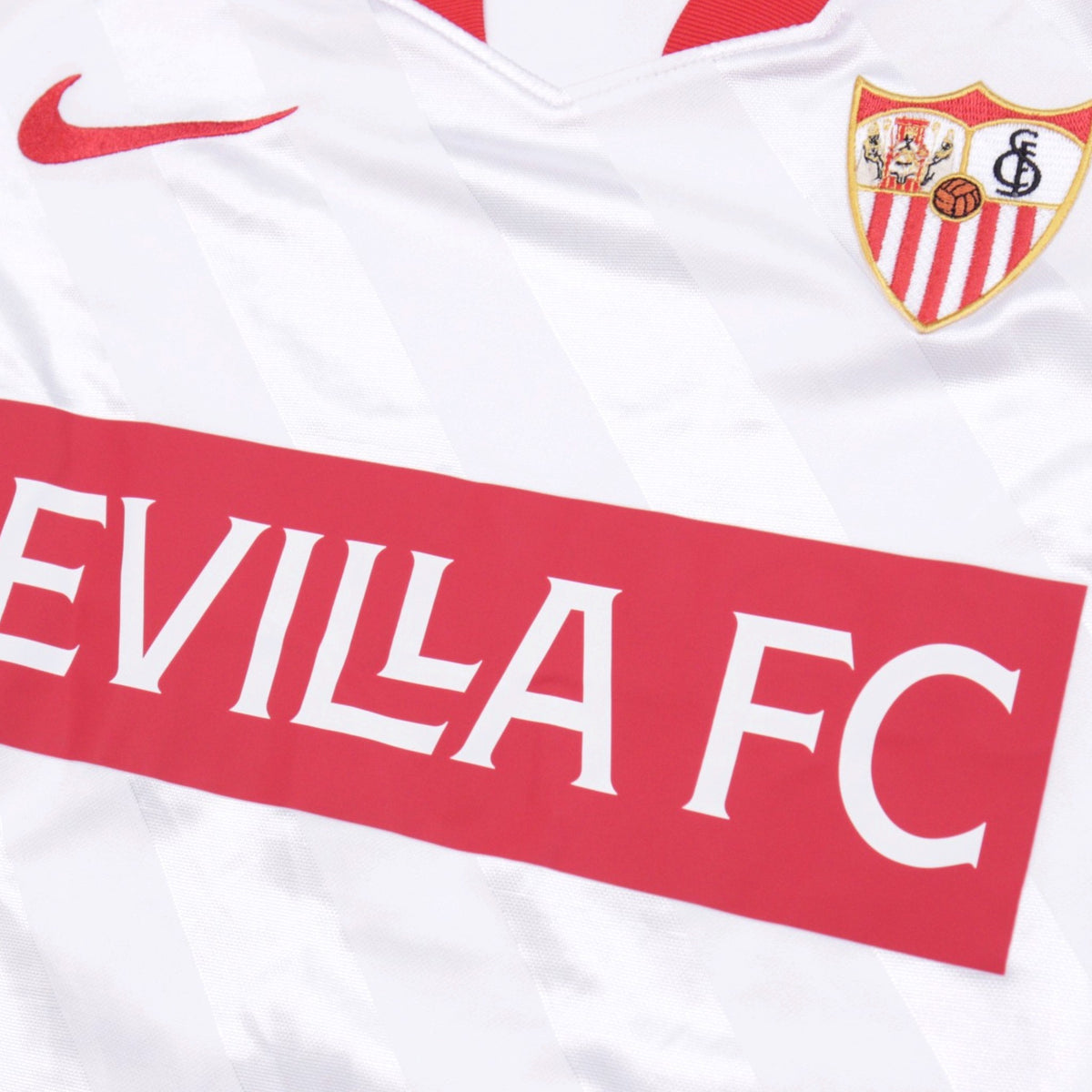 Close-up of Sevilla crest, Nike logo and Sevilla FC chest graphic
