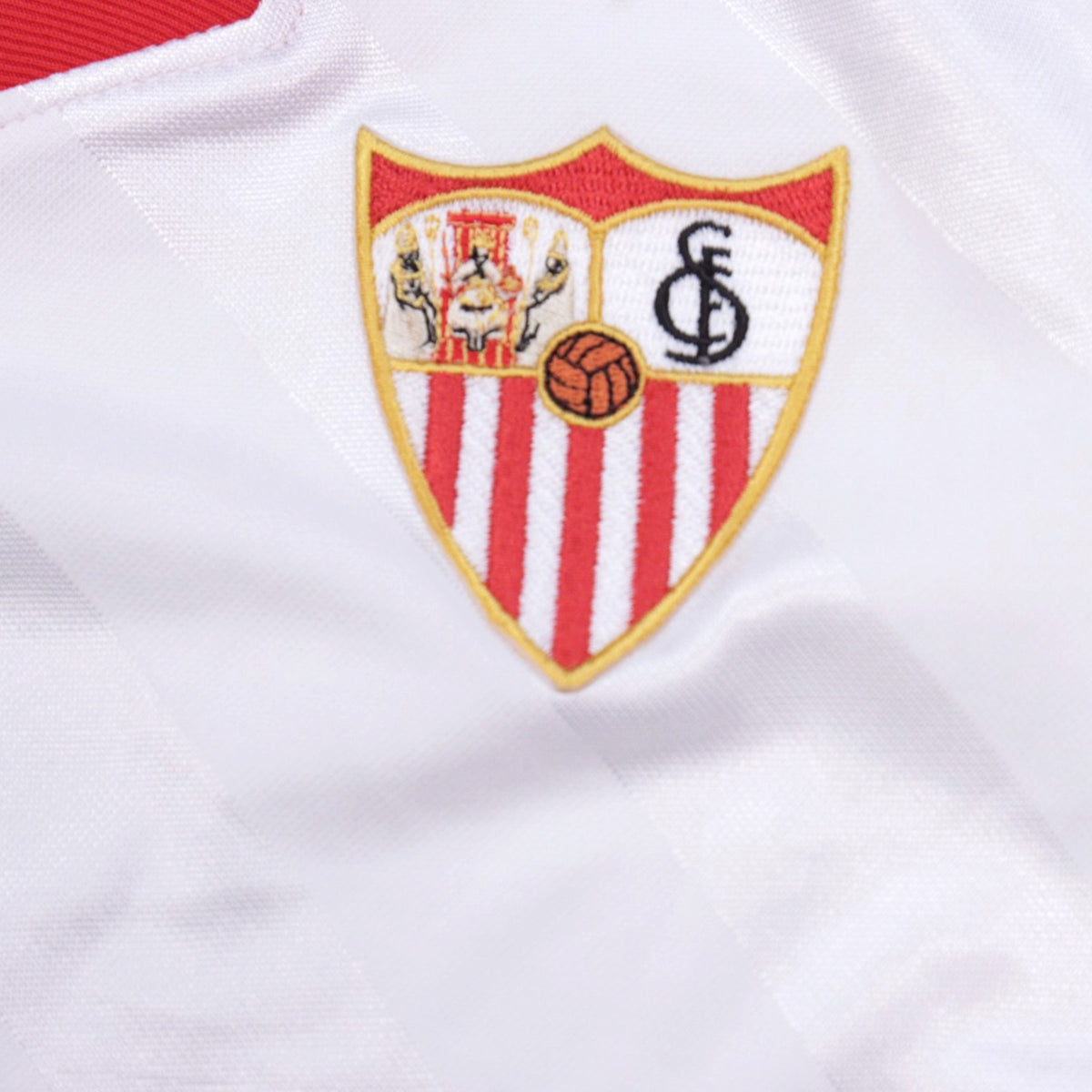 Close-up of embroidered Sevilla crest on the shirt