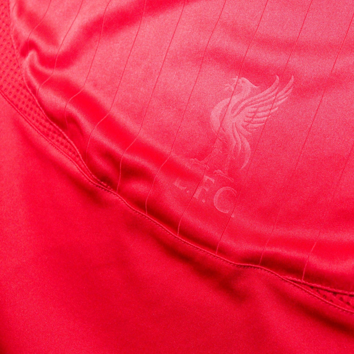 Close-up of the Liverpool crest watermark woven into the shirt fabric